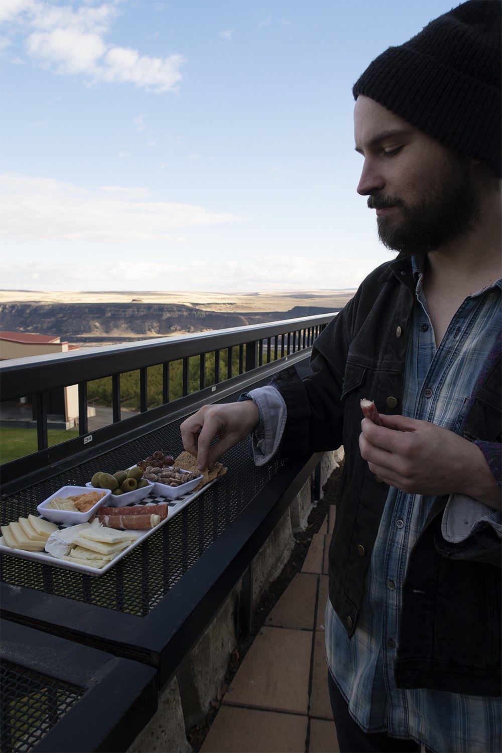 man enjoying cheese plate