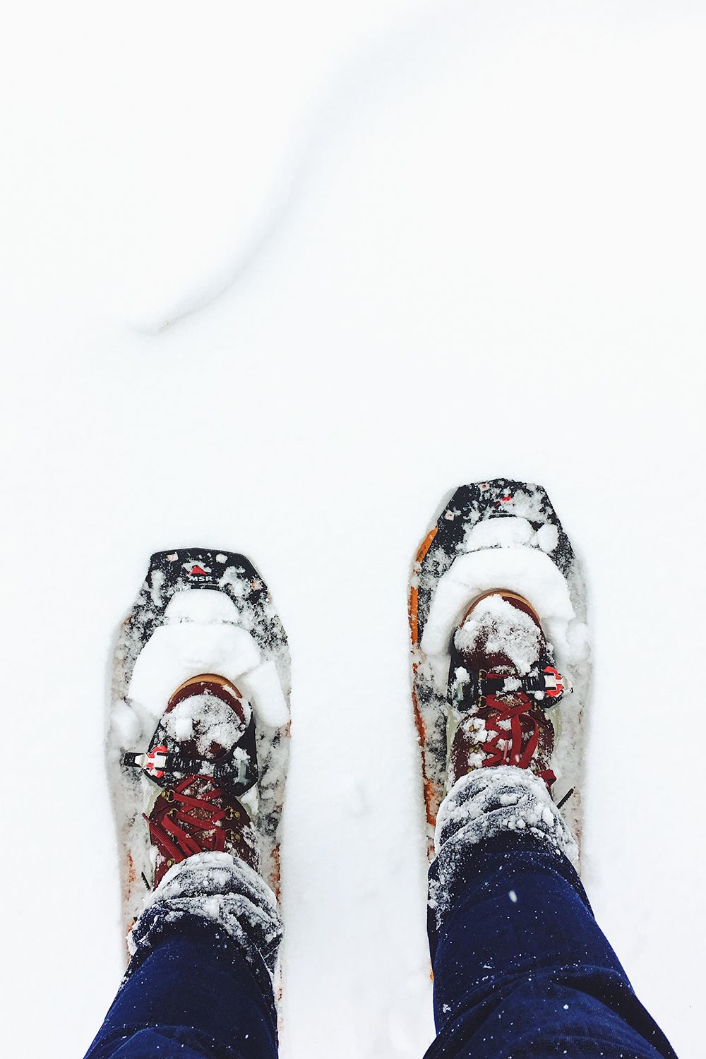 looking down at snowshoes in the snow