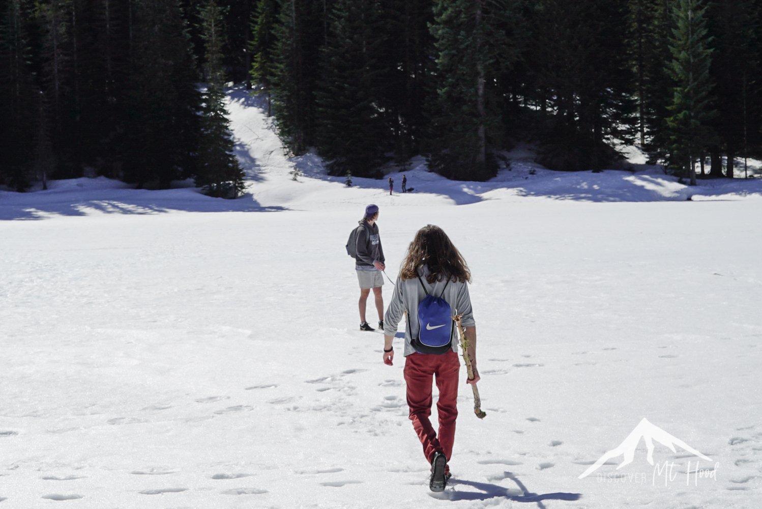 Two guys walking out to the middle of a frozen lake