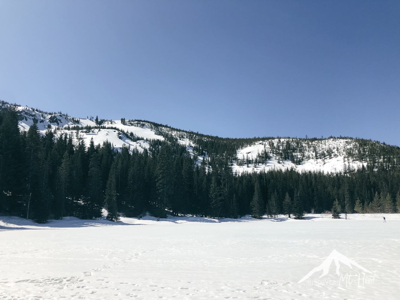 Snowy hills around mirror lake