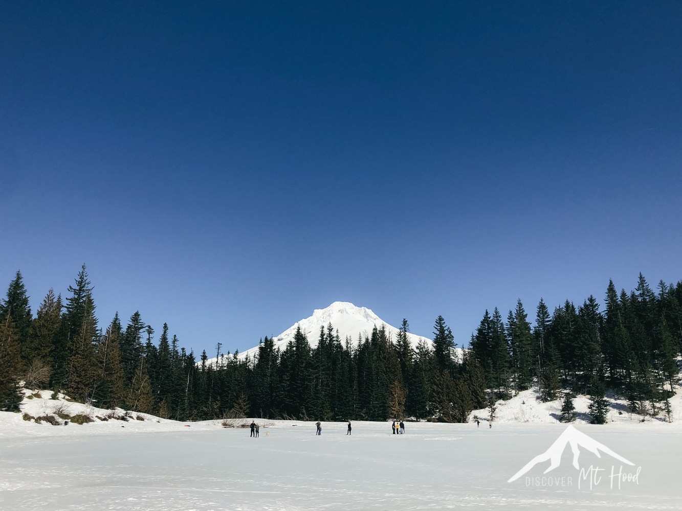 Mirror lake with people walking on it